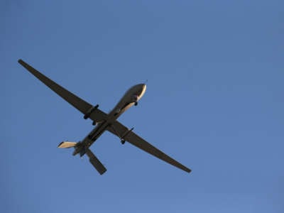 A U.S. Air Force MQ-1B Predator unmanned aerial vehicle (UAV), carrying a Hellfire missile flies over an air base after flying a mission in the Persian Gulf region on January 7, 2016.