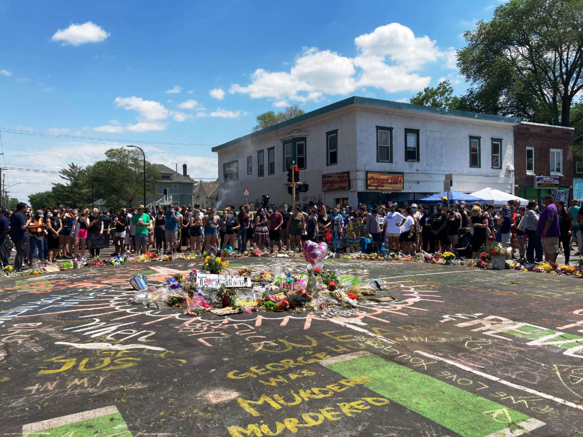 People gathered Monday at a vigil on the street corner in south Minneapolis where police killed George Floyd one week ago. On Sunday, police violently dispersed dozens of people gathered at the vigil to enforce and 8 p.m. curfew, according to local reports.