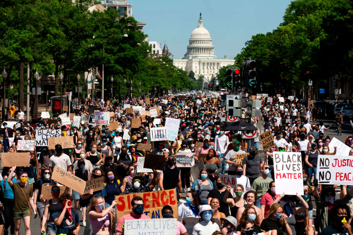 Protesters demonstrate over the death of George Floyd, by a Minneapolis police officer, at a rally on May 30, 2020, in Washington, D.C.