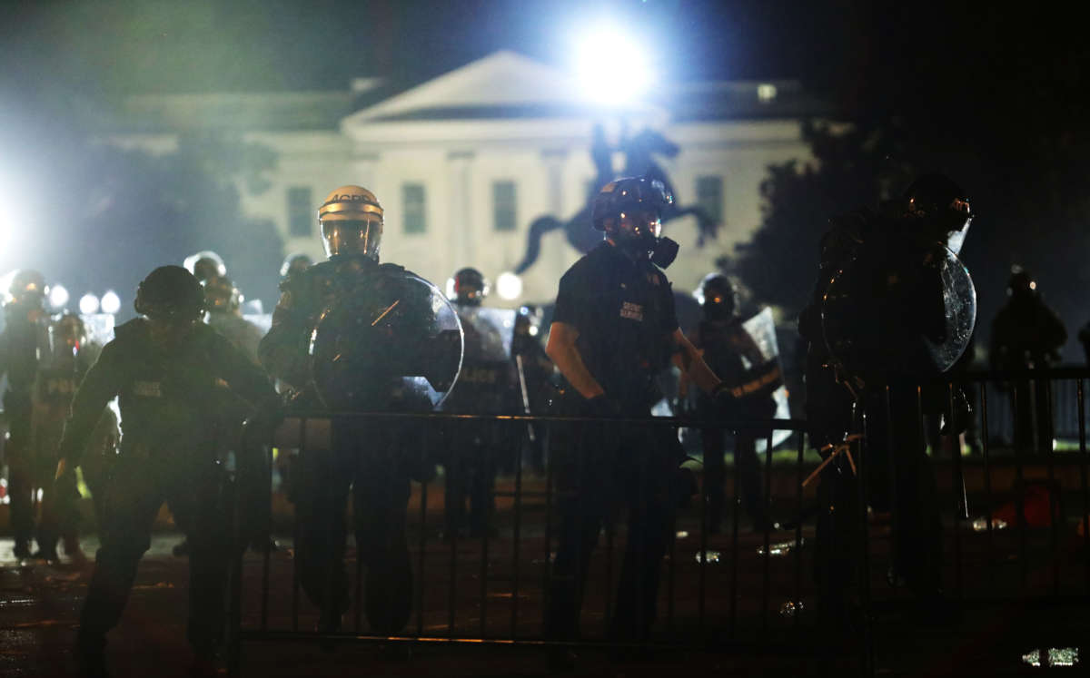 Police officers hold a perimeter during a protest near the White House in response to the killing of George Floyd, May 31, 2020, in Washington, D.C.