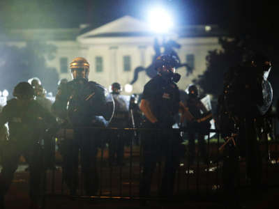 Police officers hold a perimeter during a protest near the White House in response to the killing of George Floyd, May 31, 2020, in Washington, D.C.