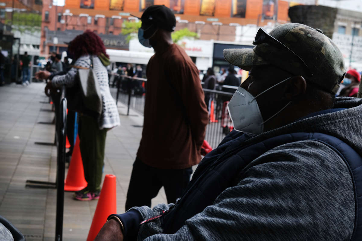 Over one thousand individuals wait in line at the Barclays Center in Brooklyn for a free food distribution on May 15, 2020, in New York City.