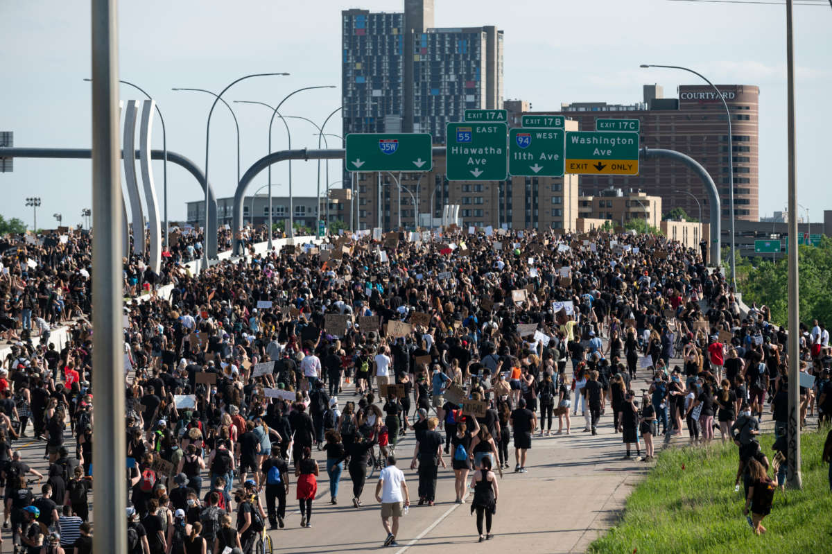 A crowd marches to protest the death of George Floyd on the I-35W bridge over the Mississippi River on May 31, 2020, in Minneapolis, Minnesota.