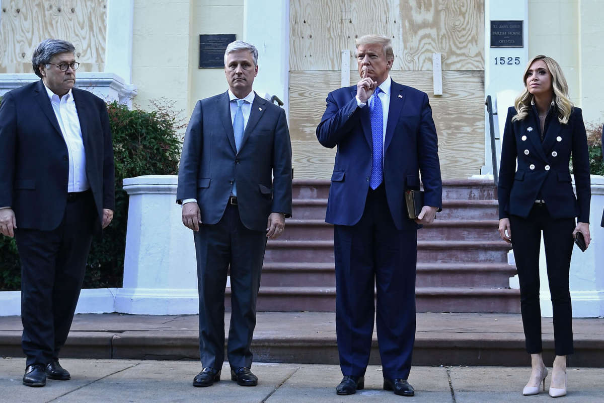 President Trump gestures alongside Attorney General William Barr, White House Chief of Staff Mark Meadows and White House press secretary Kayleigh McEnany, outside of St John's Episcopal church across Lafayette Park, after the area was cleared with tear gas for this photo op, in Washington, D.C. on June 1, 2020.