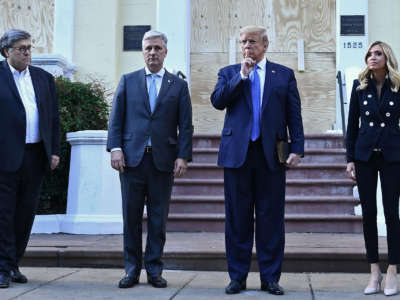 President Trump gestures alongside Attorney General William Barr, White House Chief of Staff Mark Meadows and White House press secretary Kayleigh McEnany, outside of St John's Episcopal church across Lafayette Park, after the area was cleared with tear gas for this photo op, in Washington, D.C. on June 1, 2020.