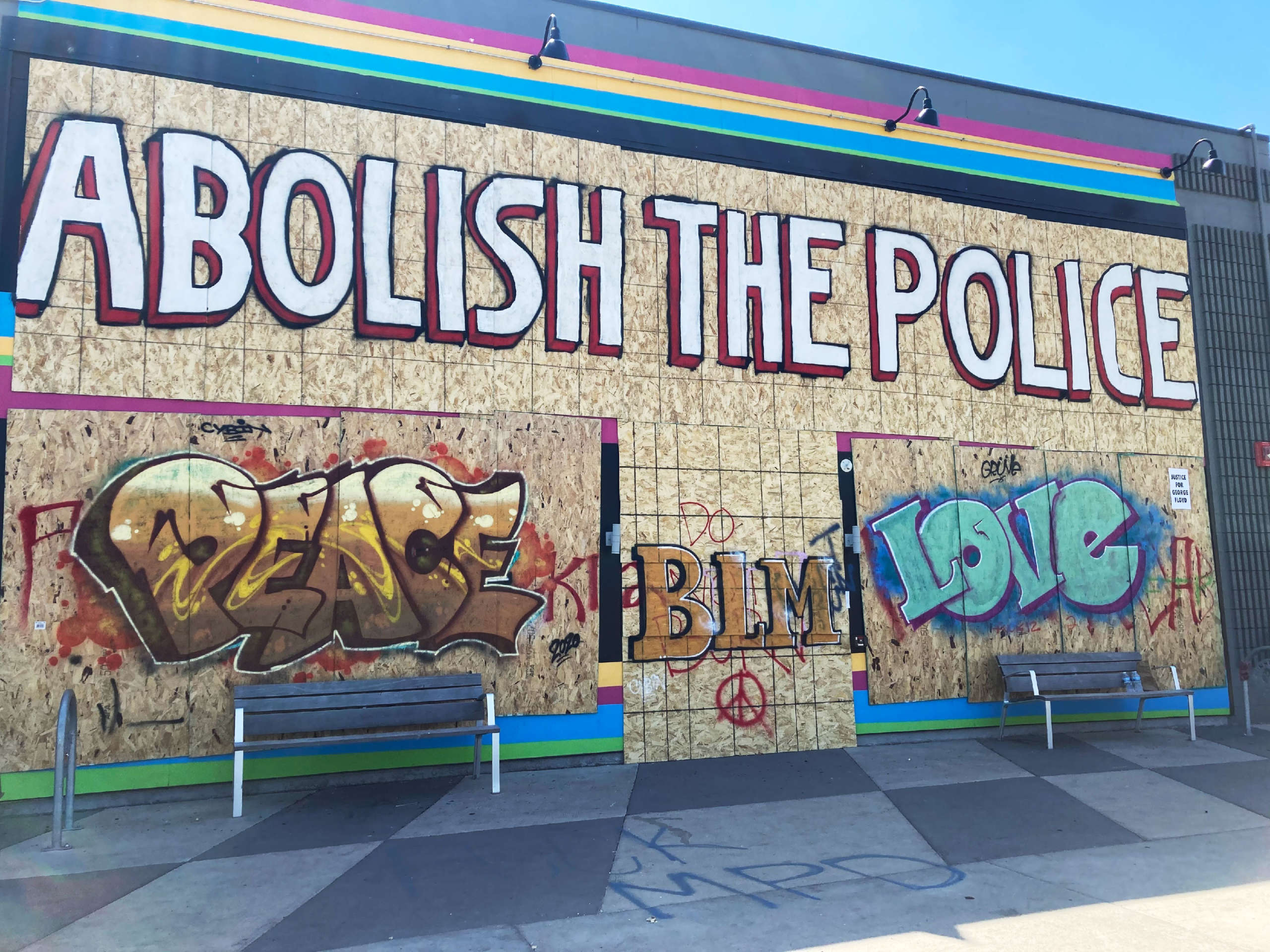 A mural near the police precinct building in south Minneapolis that was overrun and burned by protesters last week. Members of the city council are listening to police abolitionist groups and considering whether to disband the police department and replace officers with a “non-violent” public safety office.