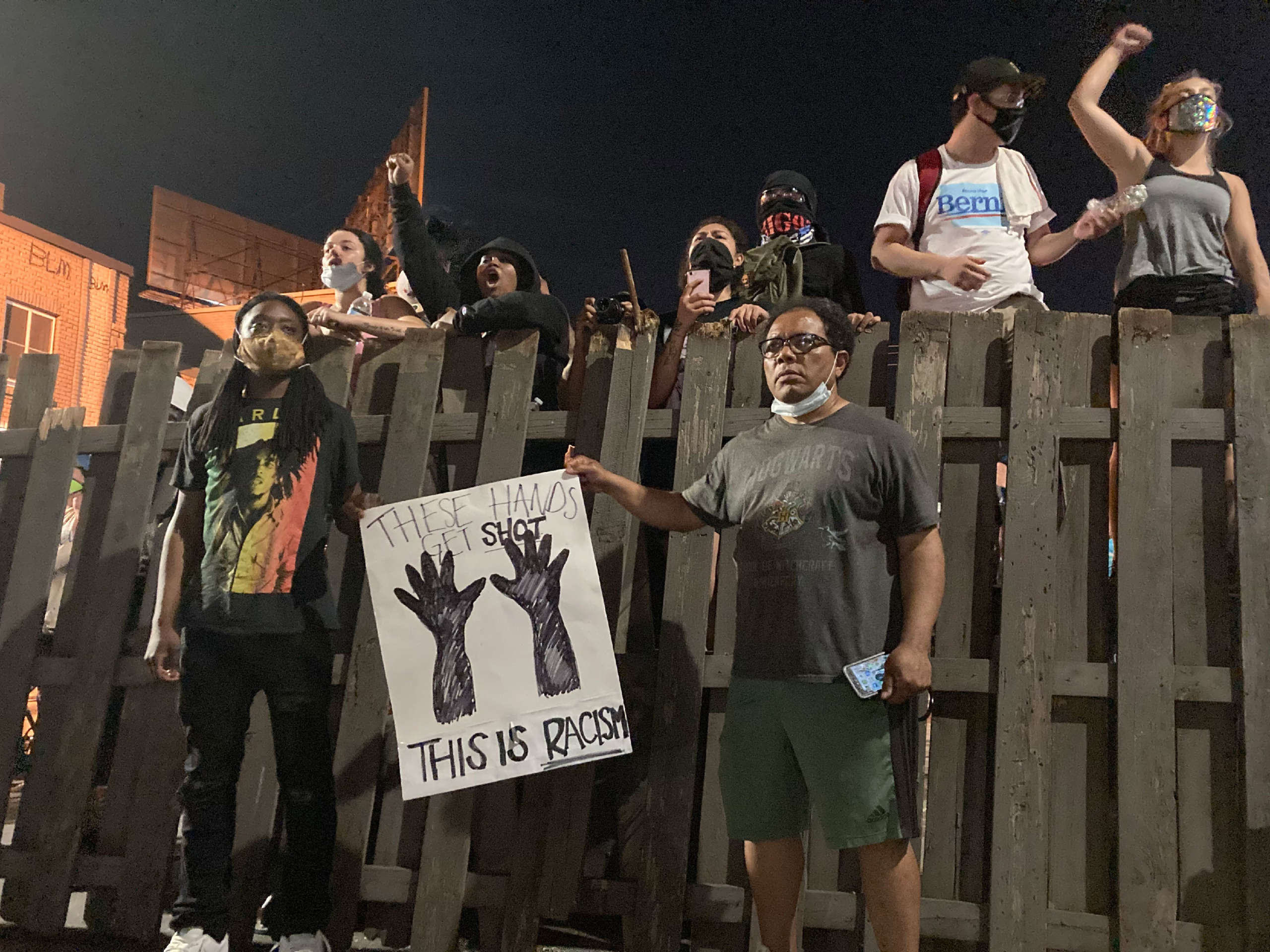 People ran to the barricades guarding the vigil for George Floyd when police passed by after curfew went into effect on Monday night, but for once the cops did not escalate, and a space declared sacred was left in peace.