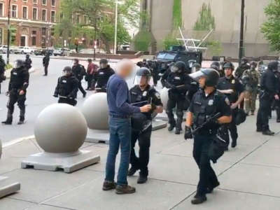 Buffalo police officers approach a 75-year-old man before knocking him down during a protest on June 4, 2020.