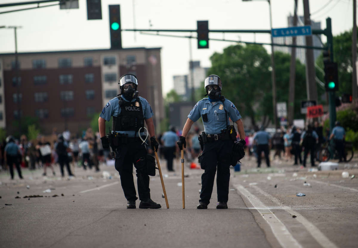 Two police officers stand outside the Third Police Precinct during protests on May 27, 2020, in Minneapolis, Minnesota.