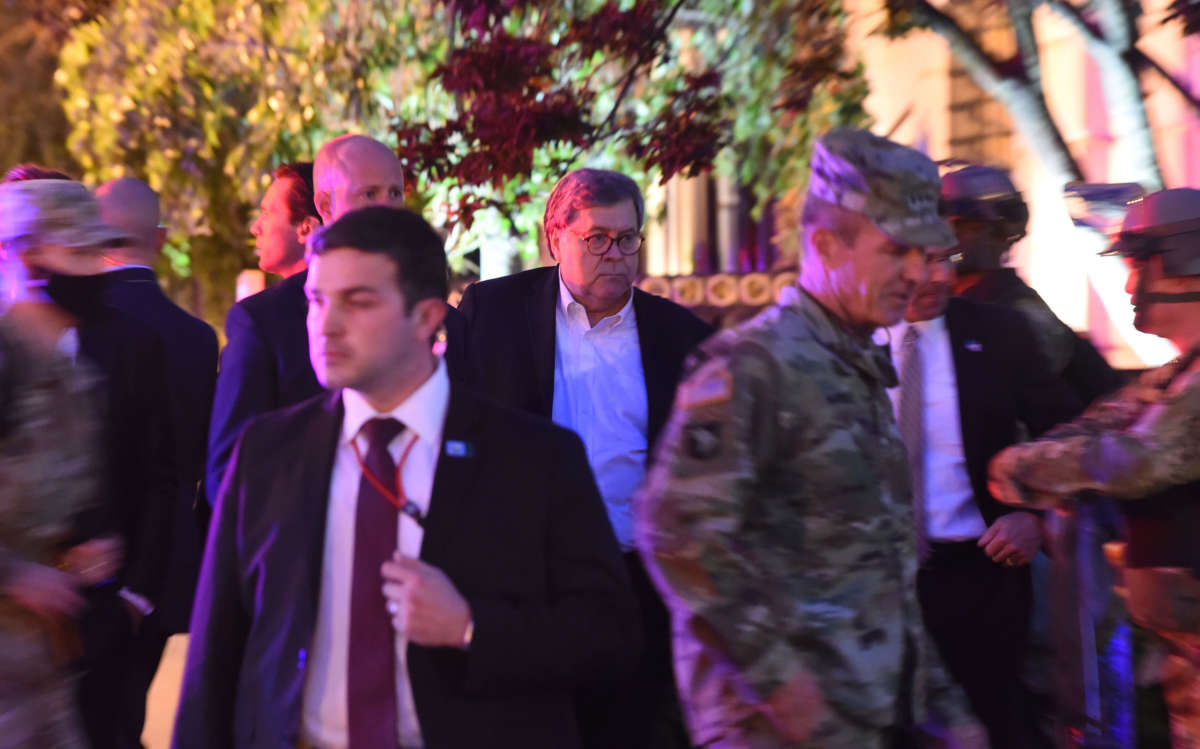 Attorney General William Barr, center, walks with military and administration staff in downtown Washington, D.C., during curfew on June 1, 2020.