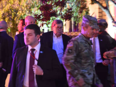 Attorney General William Barr, center, walks with military and administration staff in downtown Washington, D.C., during curfew on June 1, 2020.