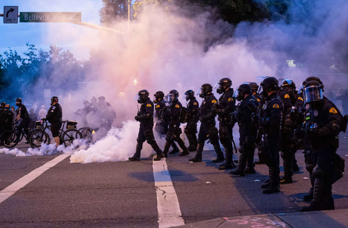 Law enforcement officers move toward demonstrators during a gathering to protest the death of George Floyd on May 31, 2020, in Bellevue, Washington.