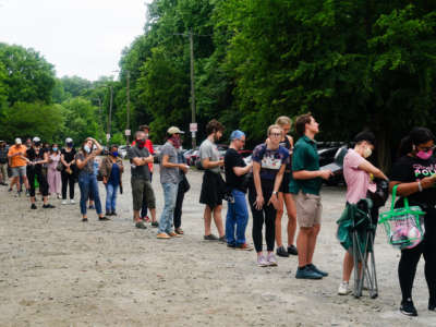 People wait in line to vote in Georgia's primary election on June 9, 2020, in Atlanta, Georgia.