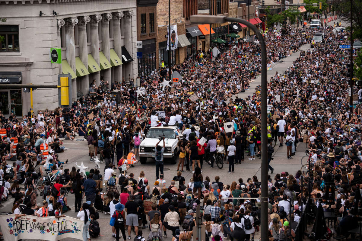 Demonstrators calling to defund the Minneapolis Police Department pause on Hennepin Avenue on June 6, 2020, in Minneapolis, Minnesota.