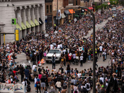 Demonstrators calling to defund the Minneapolis Police Department pause on Hennepin Avenue on June 6, 2020, in Minneapolis, Minnesota.