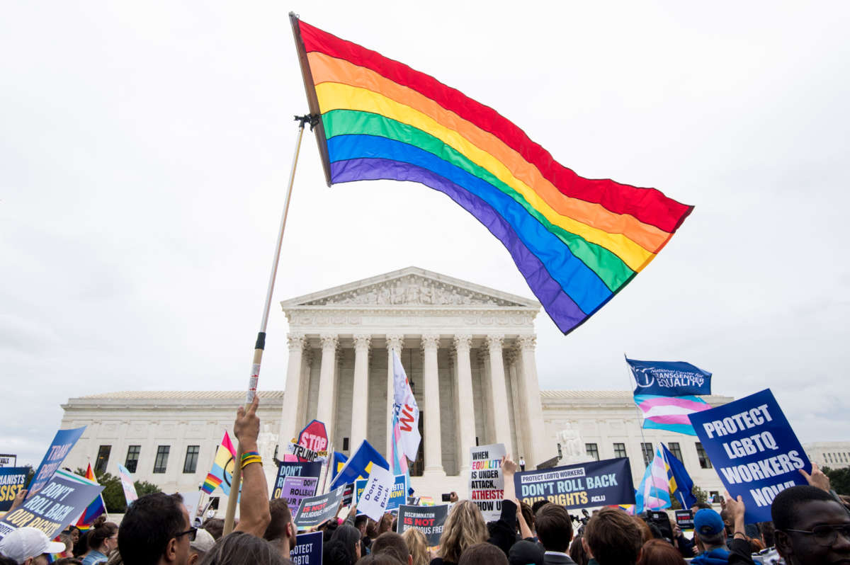 Protesters rally in front of the Supreme Court as it hears arguments on whether gay and transgender people are covered by a federal law barring employment discrimination on the basis of sex on October 8, 2019.