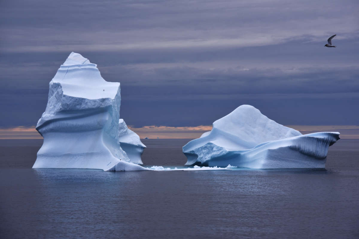 an iceberg floats in the ocean