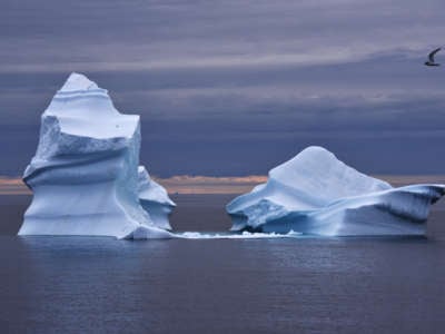 an iceberg floats in the ocean