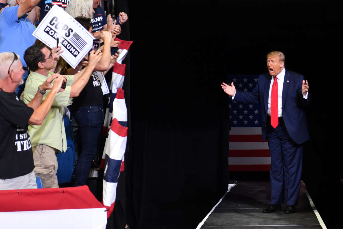 Donald Trump screams while entering an arena for a rally