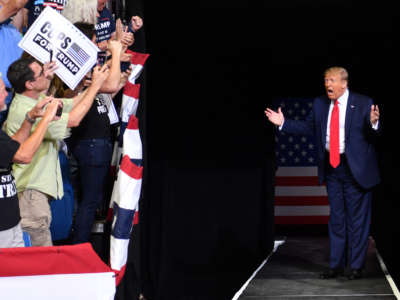 Donald Trump screams while entering an arena for a rally
