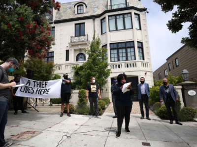 Protesters stage a demonstration in front of the home of Uber CEO Dara Khosrowshahi on June 24, 2020, in San Francisco, California.