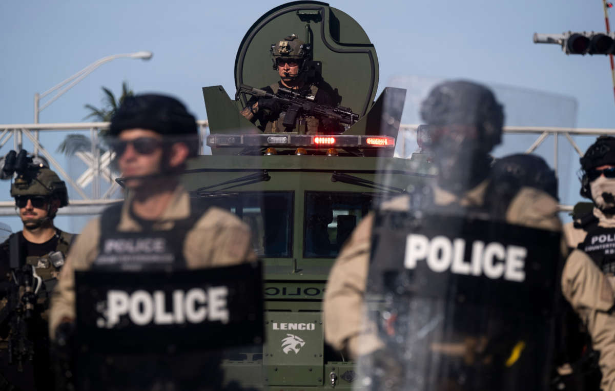 A Miami Police officer watches protestors from an armored vehicle during a rally in response to the death of George Floyd in Miami, Florida, on May 31, 2020.