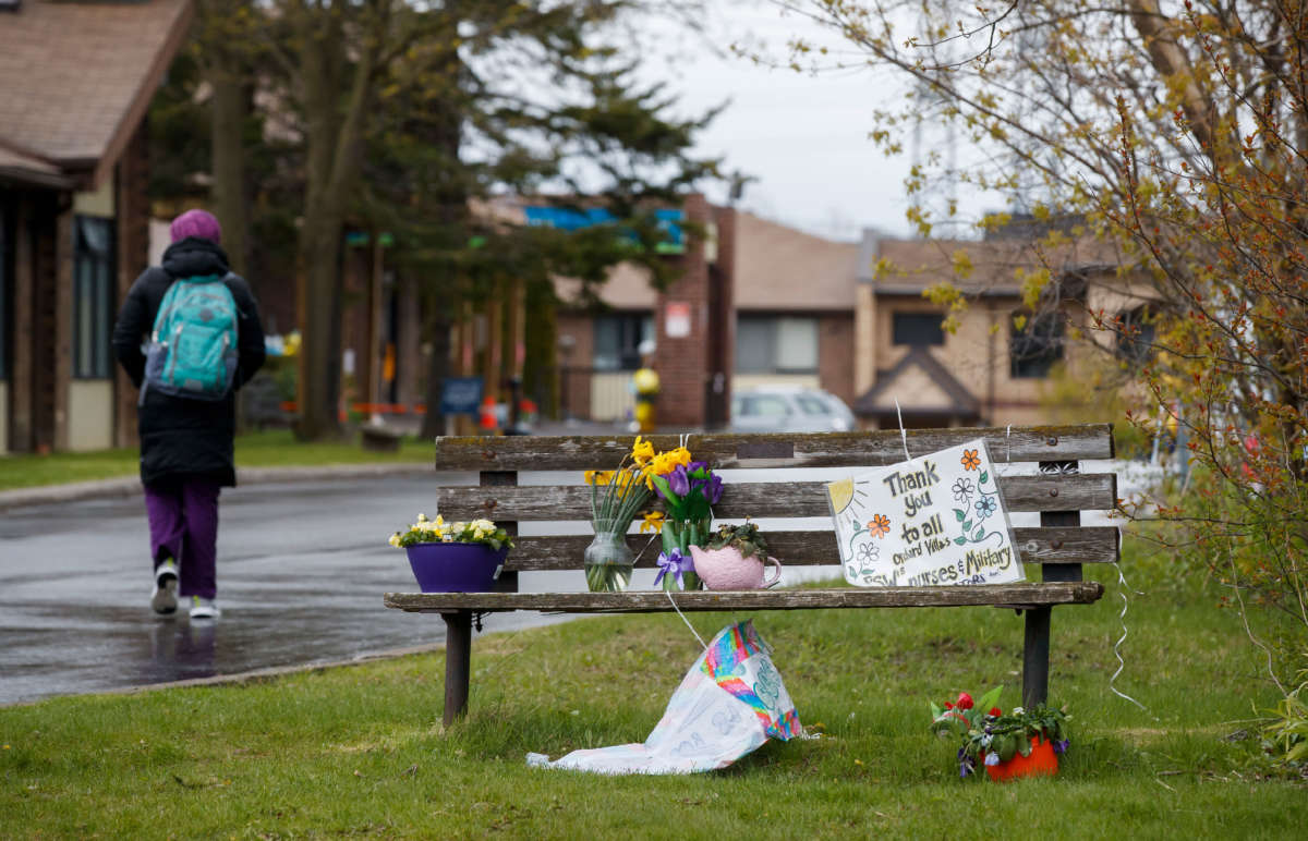 A worker walks into Orchard Villa Retirement Centre on Mother's Day, May 10, 2020, in Pickering, Canada.