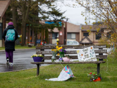 A worker walks into Orchard Villa Retirement Centre on Mother's Day, May 10, 2020, in Pickering, Canada.