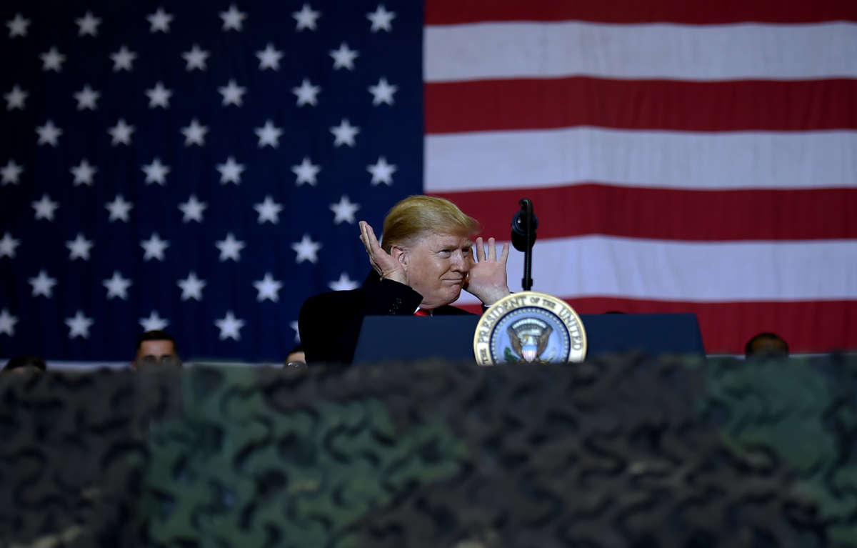 President Trump gestures while speaking to the troops during a surprise Thanksgiving Day visit at Bagram Air Field, on November 28, 2019, in Afghanistan.