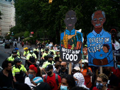 NYPD officers block the entrance of Brooklyn Bridge as protesters march near City Hall on June 25, 2020 in New York City.