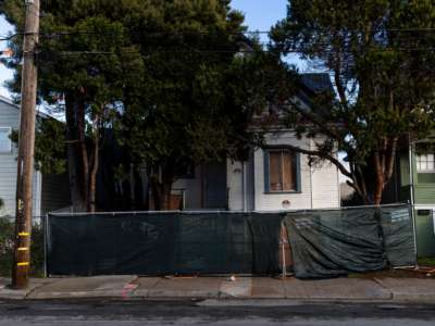 A newly-erected fence blocks the front of a vacant home that Moms 4 Housing activists occupied during a months-long protest which ended in a court ordered eviction, in Oakland, California, on January 28, 2020.