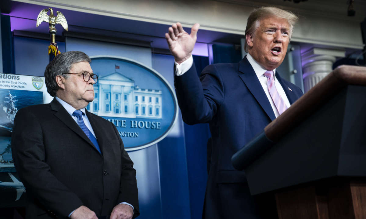Attorney General William Barr listens as President Donald J. Trump speaks with members of the coronavirus task force during a briefing in response to the COVID-19 coronavirus pandemic at the White House on April 1, 2020, in Washington, D.C.