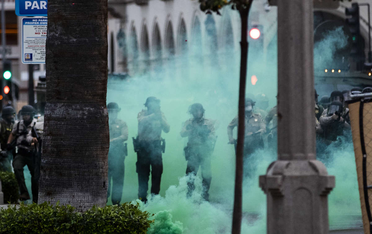 Riverside County Sheriffs fire tear gas towards protesters after they moved a fence into the street during the coronavirus pandemic on June 1, 2020, in Riverside, California.