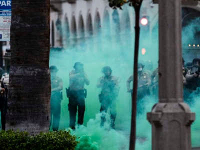 Riverside County Sheriffs fire tear gas towards protesters after they moved a fence into the street during the coronavirus pandemic on June 1, 2020, in Riverside, California.