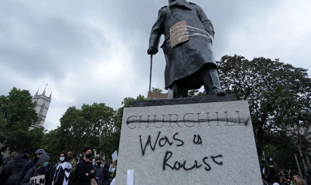 The statue of former British prime minister Winston Churchill is seen defaced, with the words (Churchill) "was a racist" written on its base in Parliament Square, central London after a demonstration outside the U.S. Embassy, on June 7, 2020.