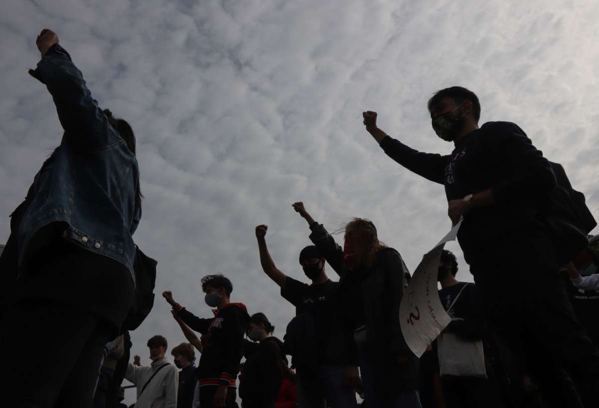 Protesters raise a fist during a march on June 10, 2020, in Frankfurt am Main, western Germany, to show solidarity with the Black Lives Matter movement in the wake of the killing of George Floyd.