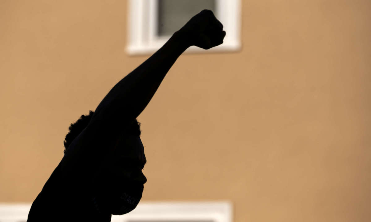 A protester holds up their fist during a demonstration outside the Minneapolis Police and Fire Union office during a rally on June 12, 2020, in Minneapolis, Minnesota.