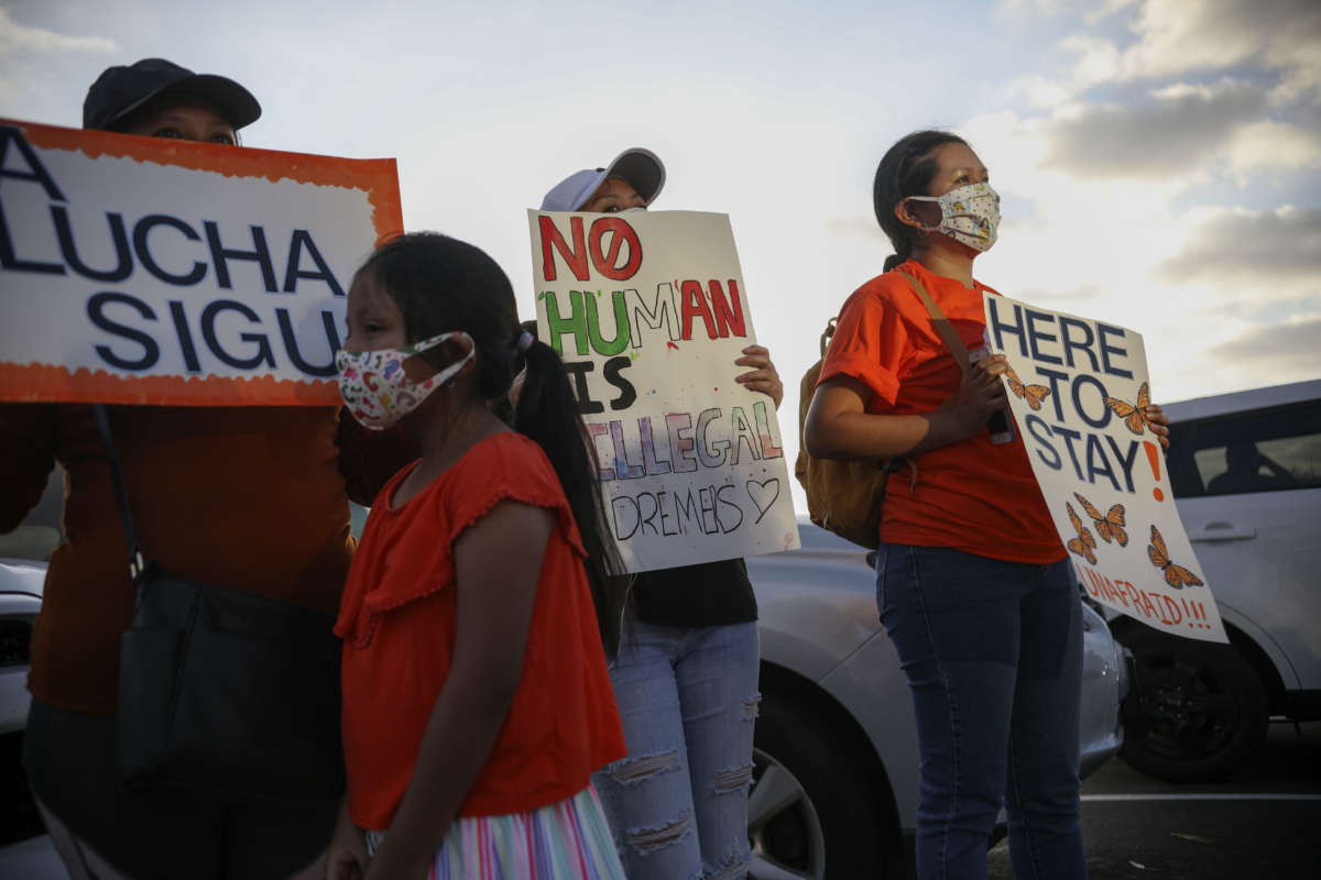 People hold signs during a rally in support of the Supreme Court's ruling in favor of the Deferred Action for Childhood Arrivals (DACA) program, in San Diego, California, June 18, 2020.