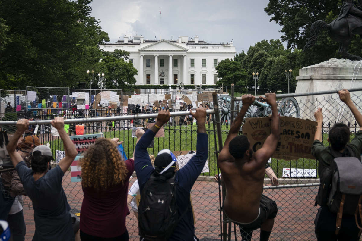 Protesters pull down a fence surrounding the statue of Andrew Jackson in an attempt to pull the statue down in Lafayette Square near the White House on June 22, 2020, in Washington, D.C.