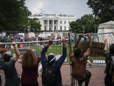 Protesters pull down a fence surrounding the statue of Andrew Jackson in an attempt to pull the statue down in Lafayette Square near the White House on June 22, 2020, in Washington, D.C.