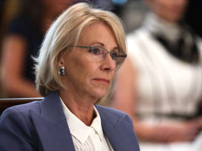 Secretary of Education Betsy DeVos listens during a cabinet meeting in the East Room of the White House on May 19, 2020, in Washington, D.C.
