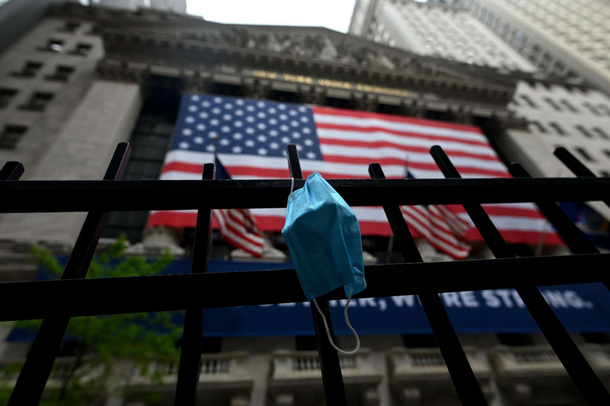 A face mask is seen in front of the New York Stock Exchange on May 26, 2020, at Wall Street in New York City.