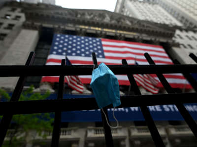 A face mask is seen in front of the New York Stock Exchange on May 26, 2020, at Wall Street in New York City.