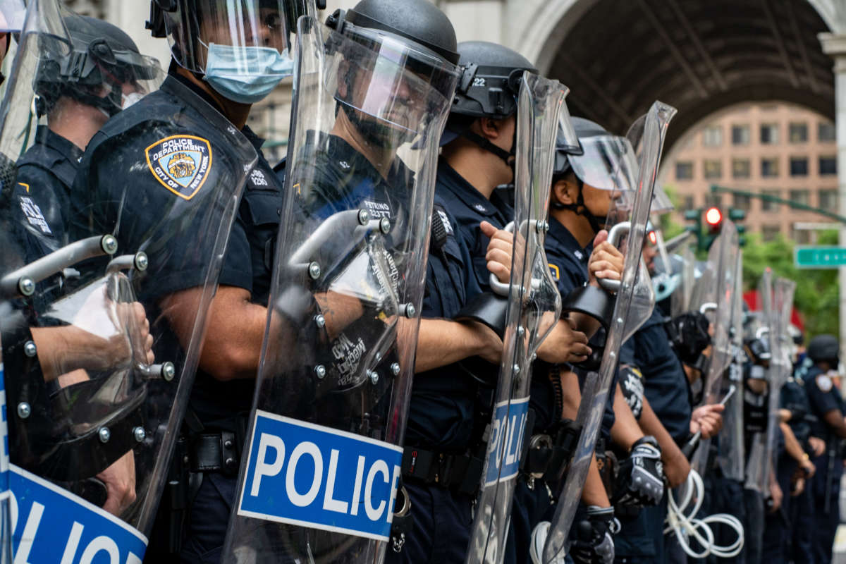 Police officers line up in a row before protesters on July 1, 2020, in New York City.