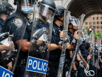 Police officers line up in a row before protesters on July 1, 2020, in New York City.