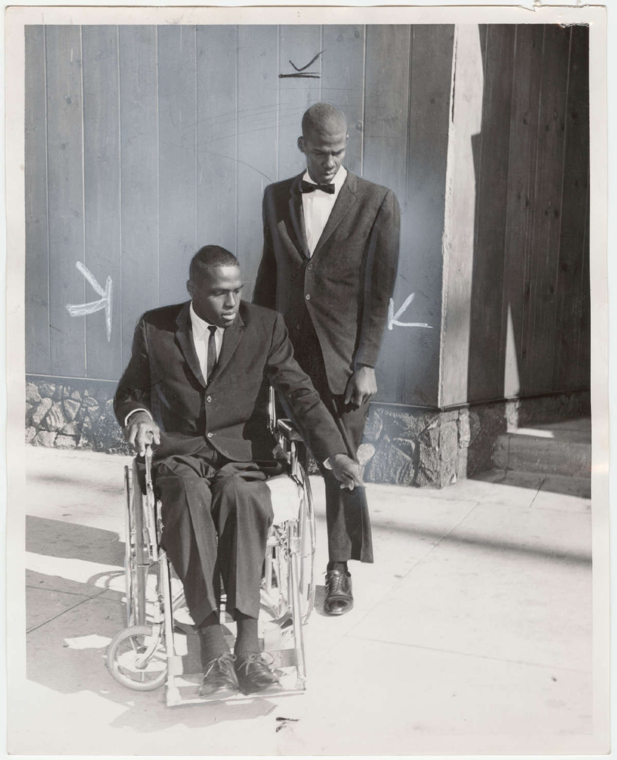 William Rogers, who experienced paralysis due to police bullets, appears with his brother Robert.