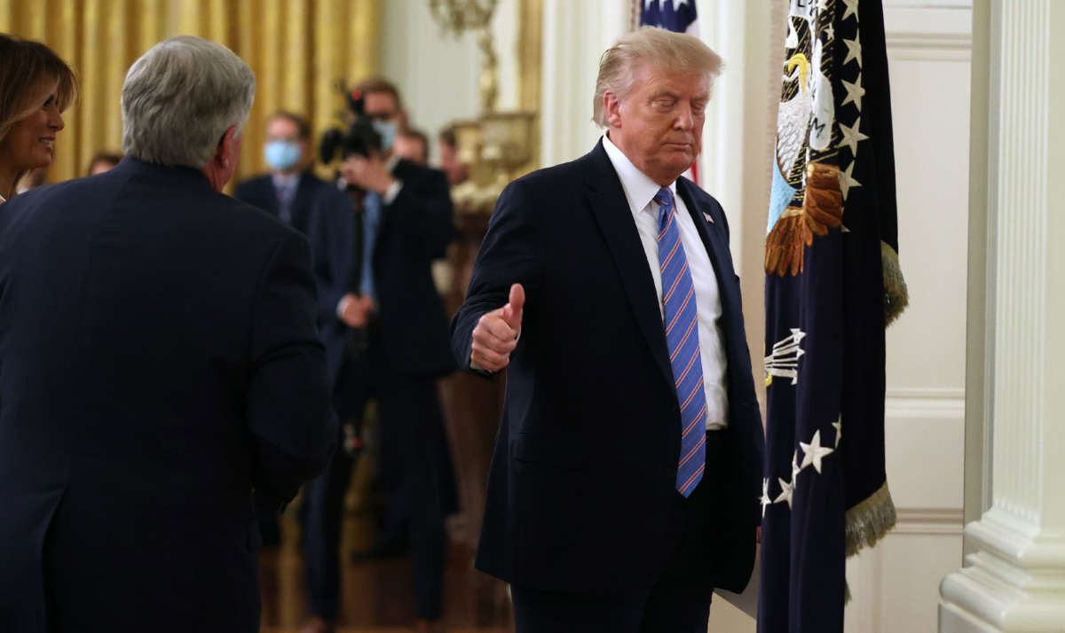 President Trump gives a thumbs-up as he leaves a meeting in the East Room at the White House, July 7, 2020, in Washington, D.C.