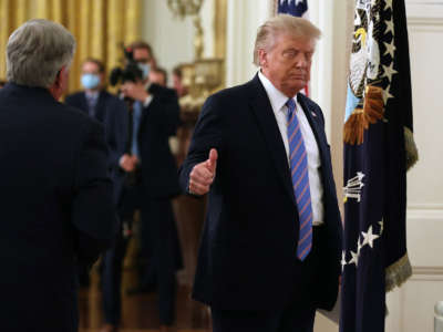 President Trump gives a thumbs-up as he leaves a meeting in the East Room at the White House, July 7, 2020, in Washington, D.C.