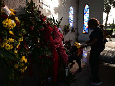 A woman stands at the burial site of George Floyd in the Houston Memorial Gardens cemetery in Pearland, Texas, on June 9, 2020.