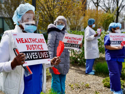 Public health workers, doctors and nurses protest over lack of sick pay and personal protective equipment outside a hospital in the borough of the Bronx on April 17, 2020, in New York.